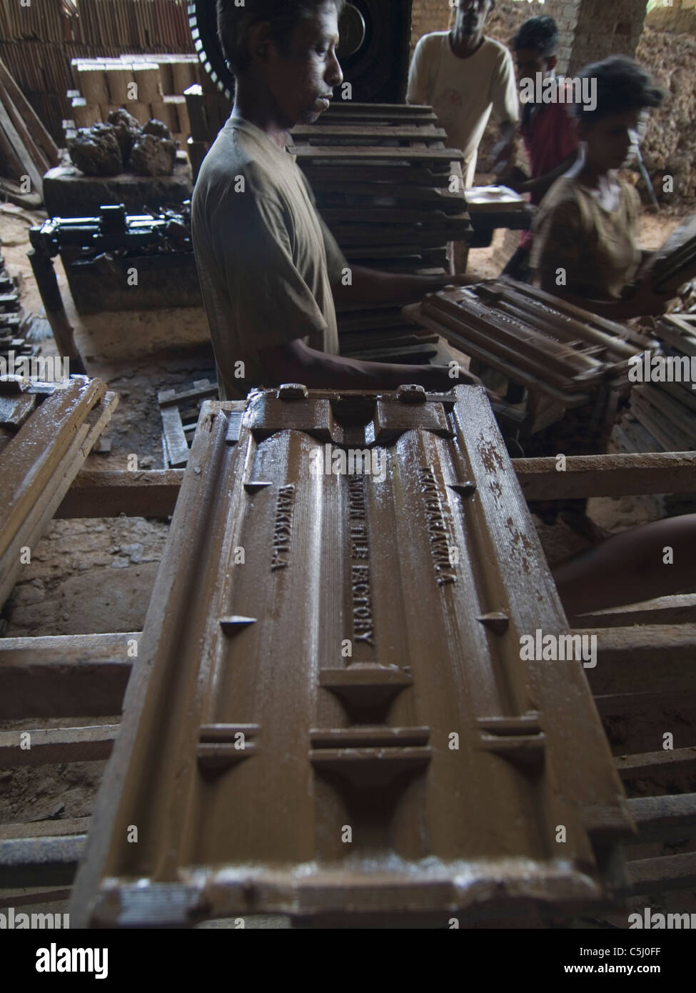 Laborers at work in a ceramic roofing tile factory in Negombo, Sri