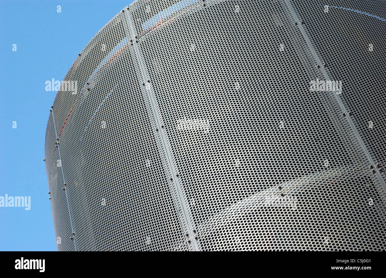 Curved punched metal surface. Stock Photo