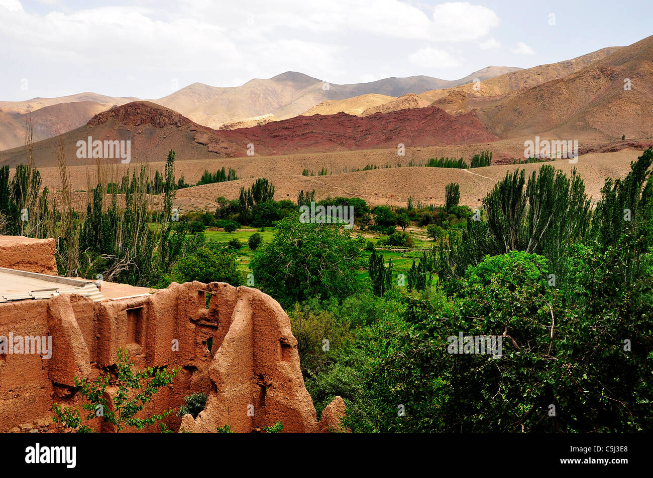 The ruin of an abandoned adobe building and mountain landscape in Iran. Stock Photo