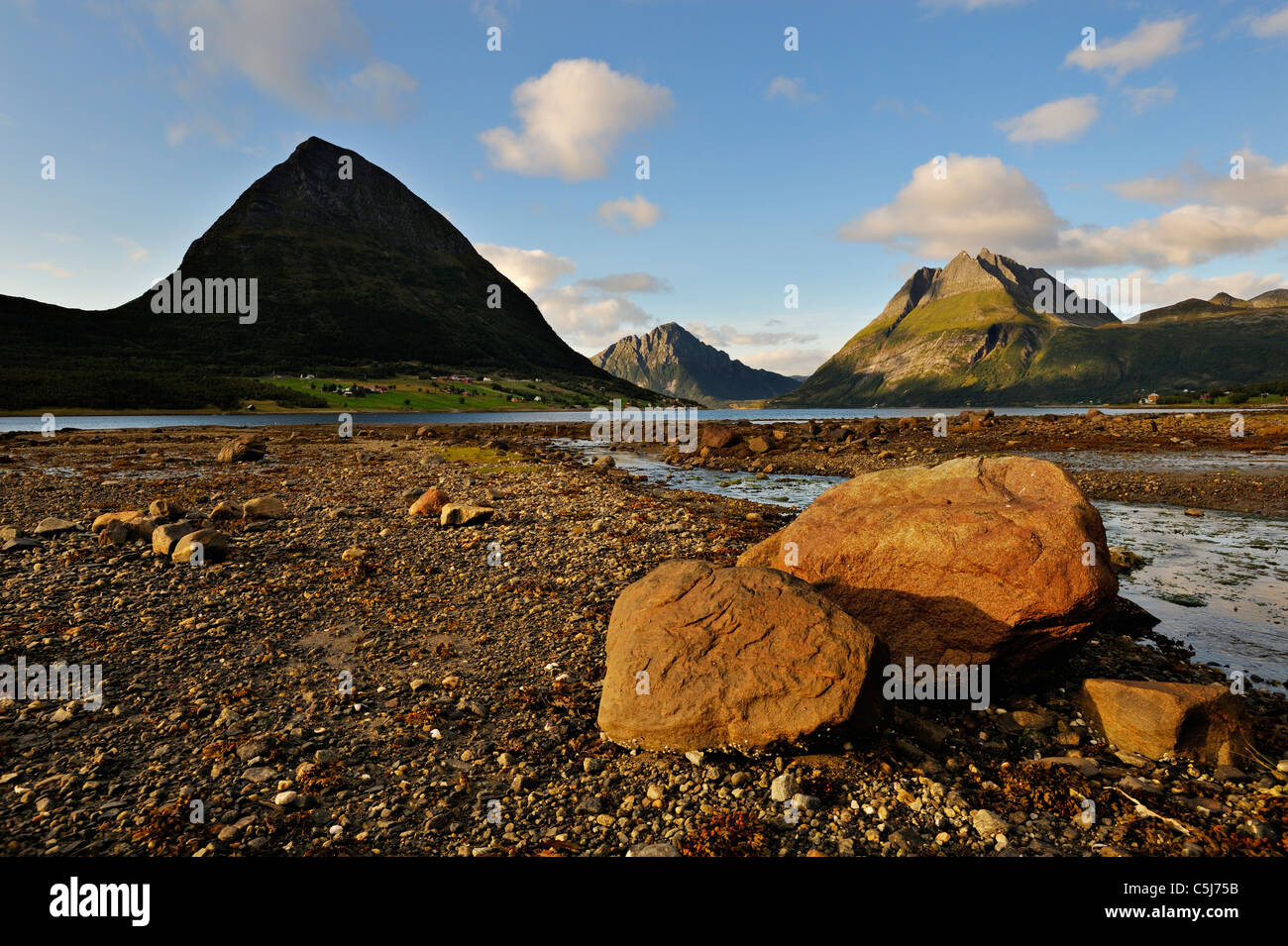 The island of Aldra with the Hjarttinden and Liatinden peaks from the shore at Haugland, north-west Norway. Stock Photo