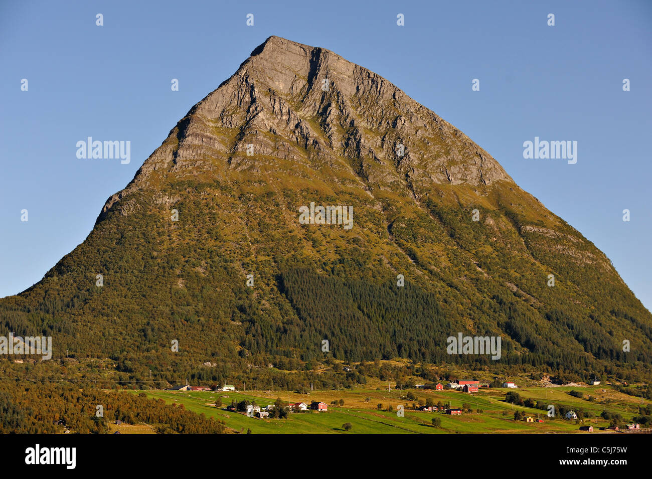 The island and village of Aldra with the Hjarttinden mountain from Haugland, north-west Norway. Stock Photo