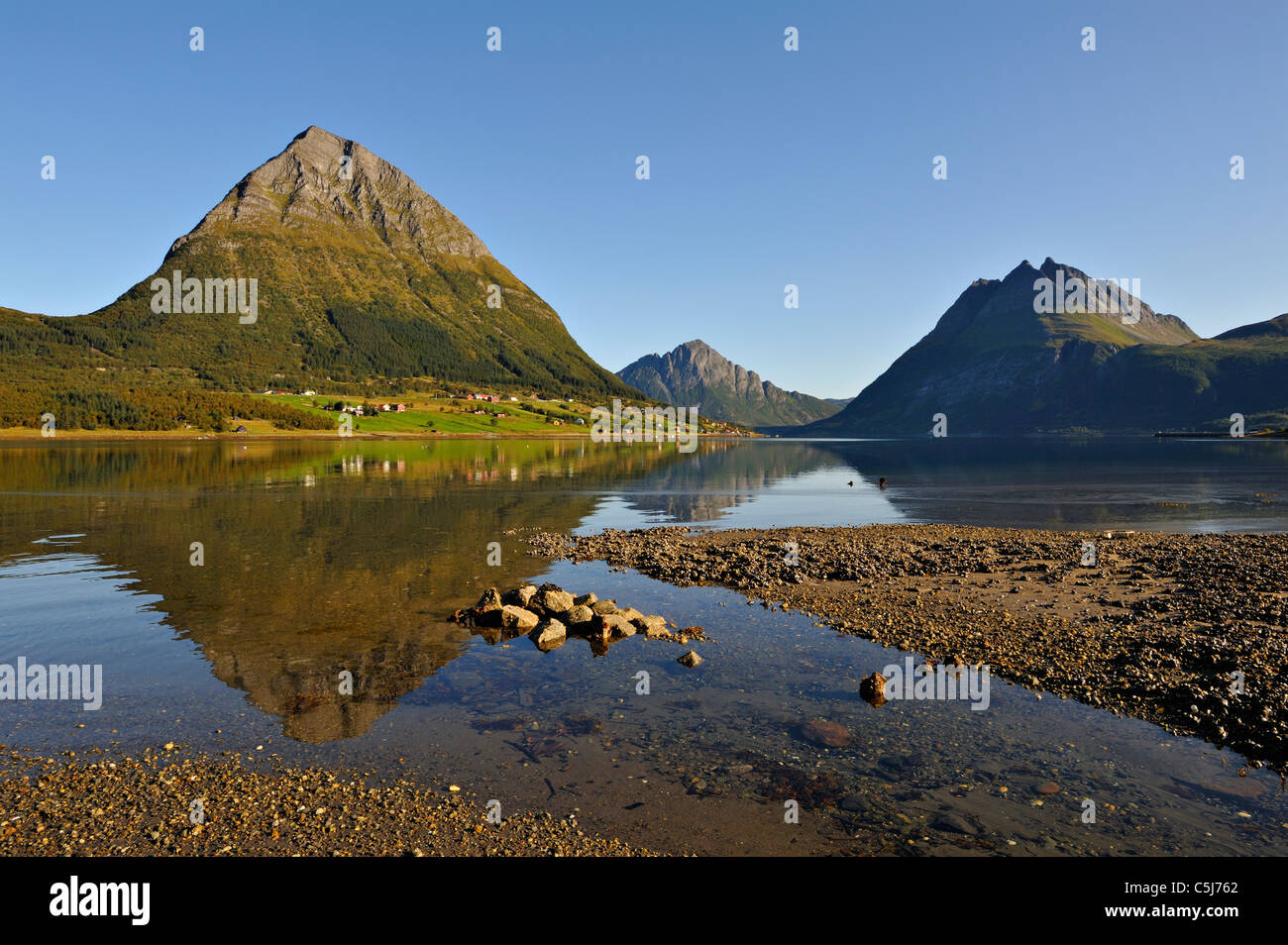 The island of Aldra with the Hjarttinden and Liatinden peaks from the shore at Haugland, north-west Norway. Stock Photo