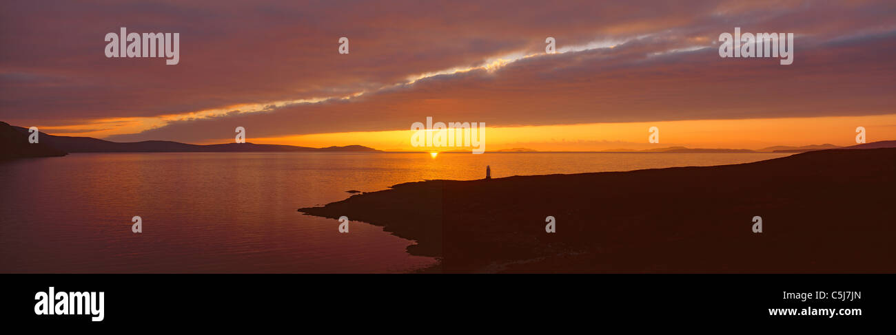 Dramatic sunset over the lighthouse at Rhue near Ullapool, and Outer Loch Broom, Wester Ross, northern Scotland, UK Stock Photo