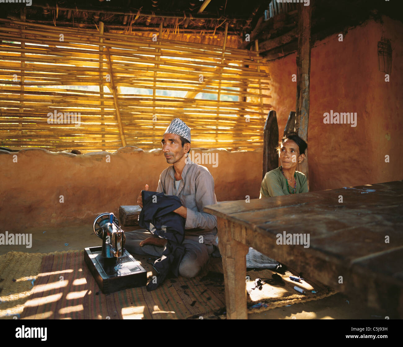 The village tailor and his wife in the village of Sultibari in east Nepal Stock Photo