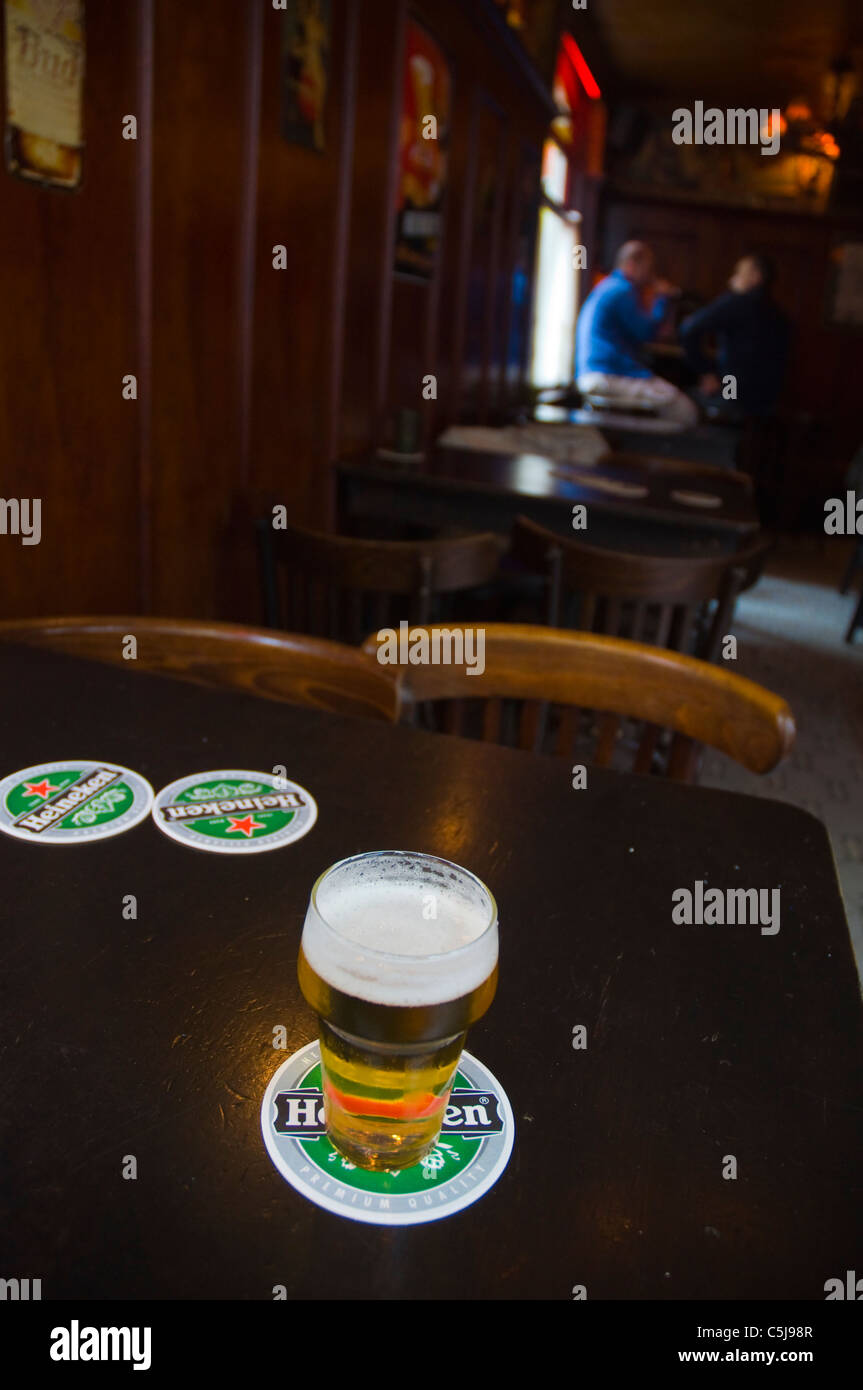 Typical 250ml glass of Heineken beer in a pub along Zeedijk street Amsterdam the Netherlands