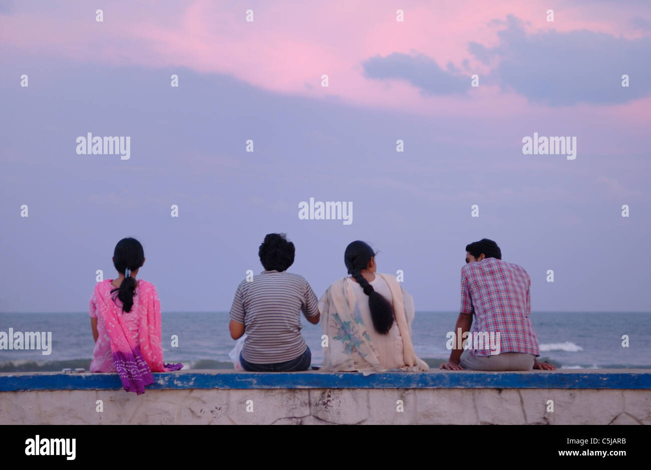 Group of Indian people relaxing after sunset at Chennai beach. India, Tamil Nadu, Chennai (Madras).  No releases available. Stock Photo