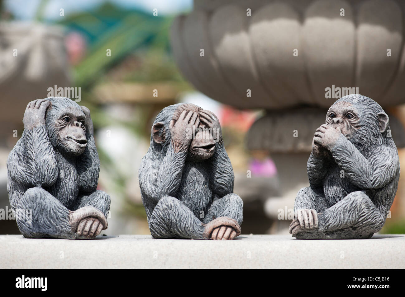 Three wise Monkeys . Stone garden ornaments Stock Photo