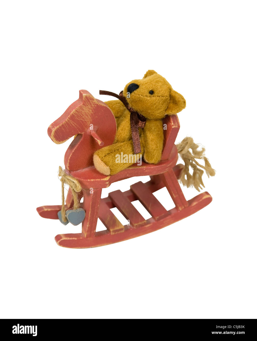 Antique retro teddy bear riding a painted wooden retro rocking horse