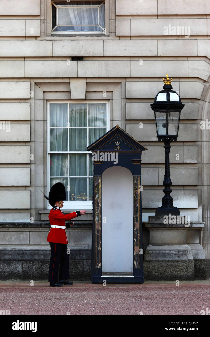 Scots Guard of Royal Queen's Guard approaching sentry box outside