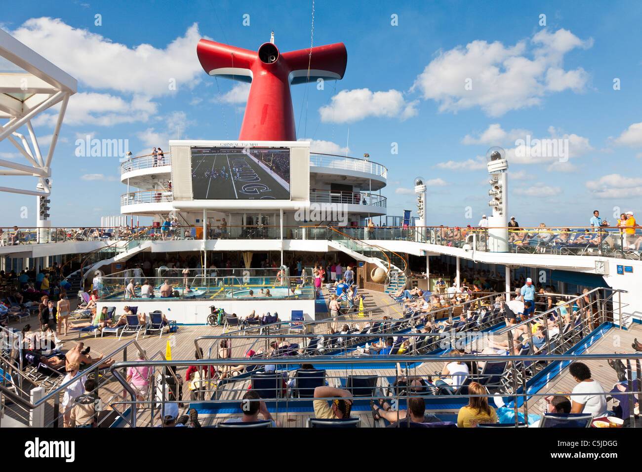 Cruise passengers watching NFL football game on deck of Carnival's
