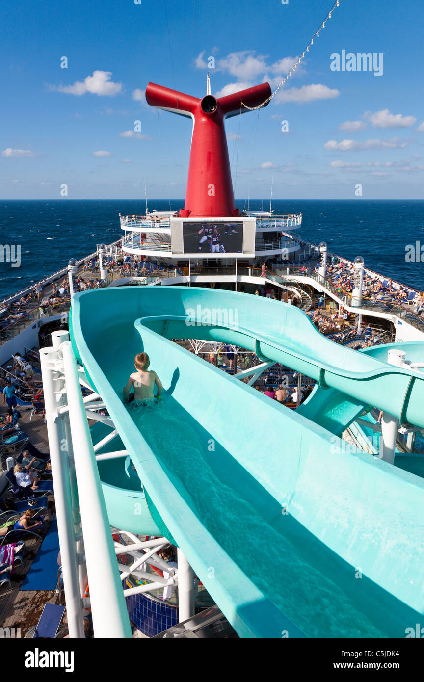 Young boy sliding on water slide on Carnival's Triumph cruise ship in the Gulf of Mexico Stock Photo