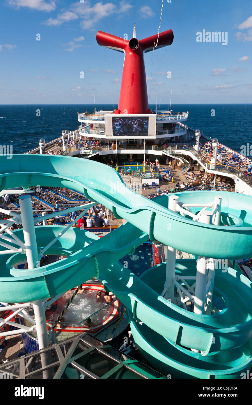 Cruise passengers on deck and waterslide on Carnival's Triumph cruise ship in the Gulf of Mexico Stock Photo