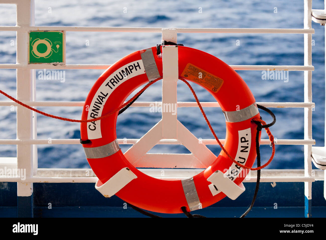 Life saving ring mounted on railing of Carnival's Triumph cruise ship in the Gulf of Mexico Stock Photo