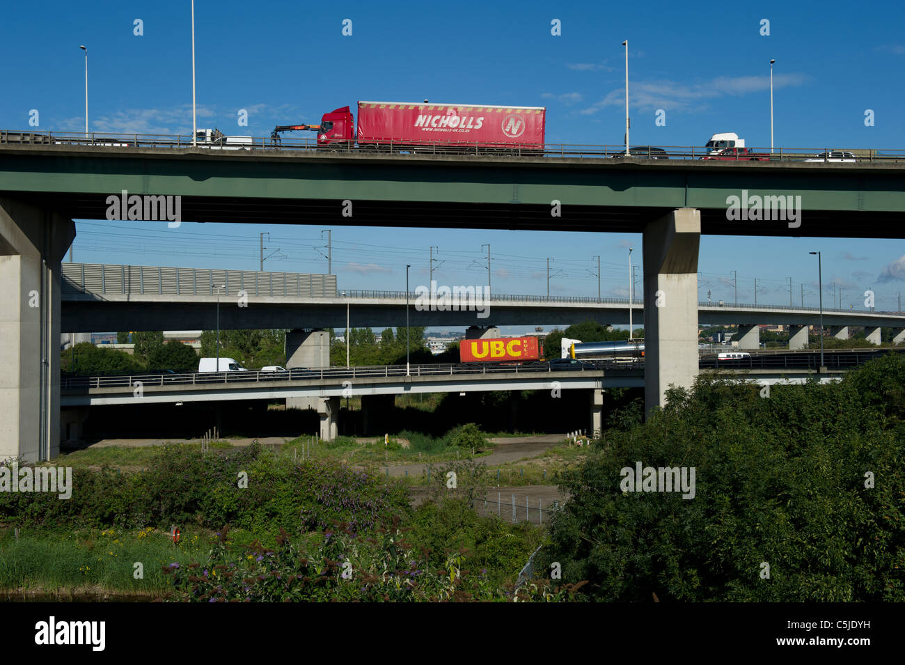 Three way traffic. Two directions of traffic using Dartford River Crossing and Eurostar track passing below. Stock Photo
