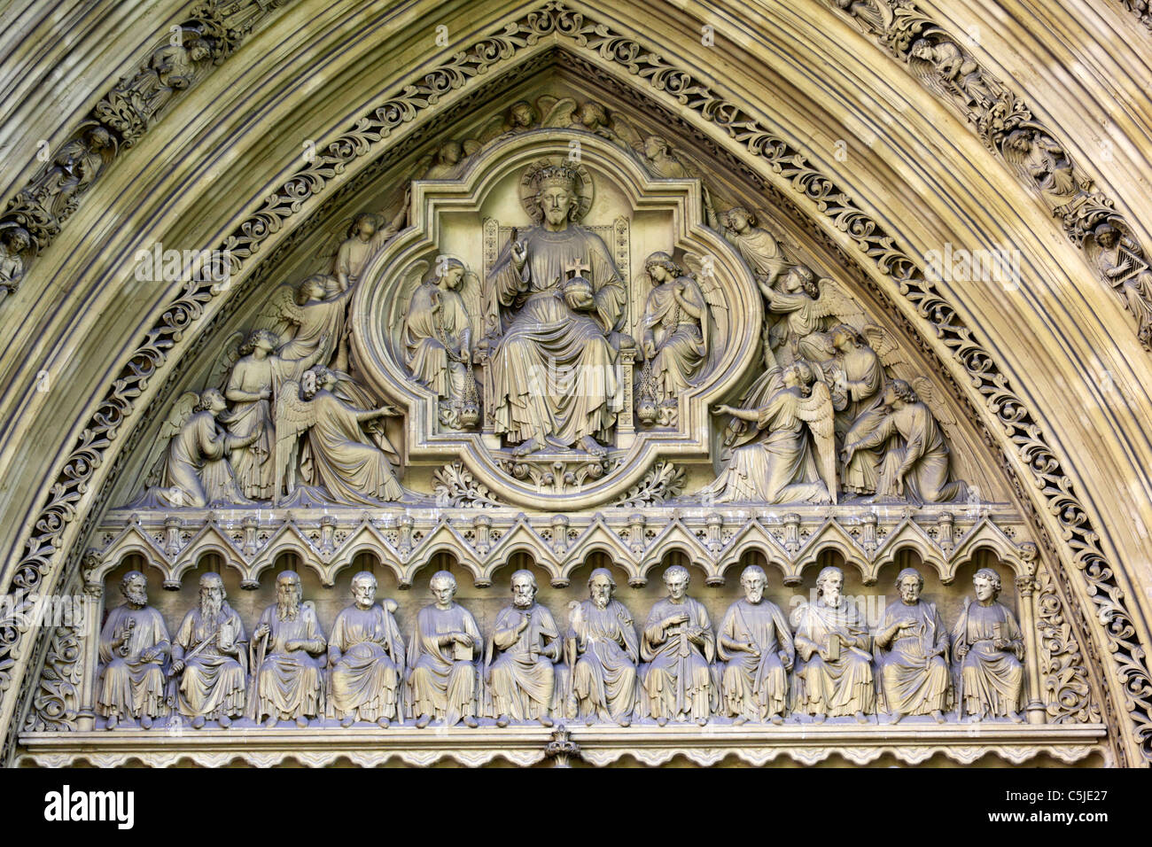 Detail of stone carvings of Jesus, angels and disciples on tympanum of Great North Door, Westminster Abbey, London, England Stock Photo