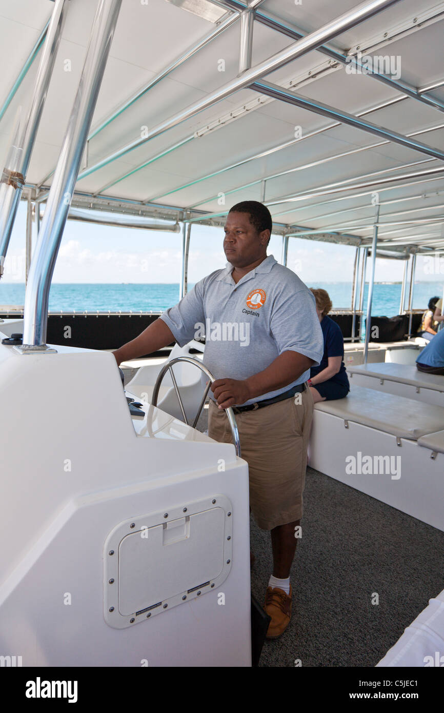 Tender boat captain carries cruise ship passengers to and from Belize City, Belize Stock Photo