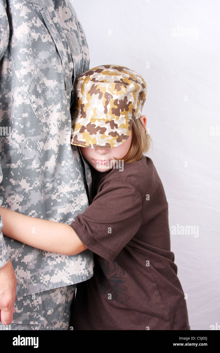 An adult soldier getting a hug from a child Stock Photo Alamy