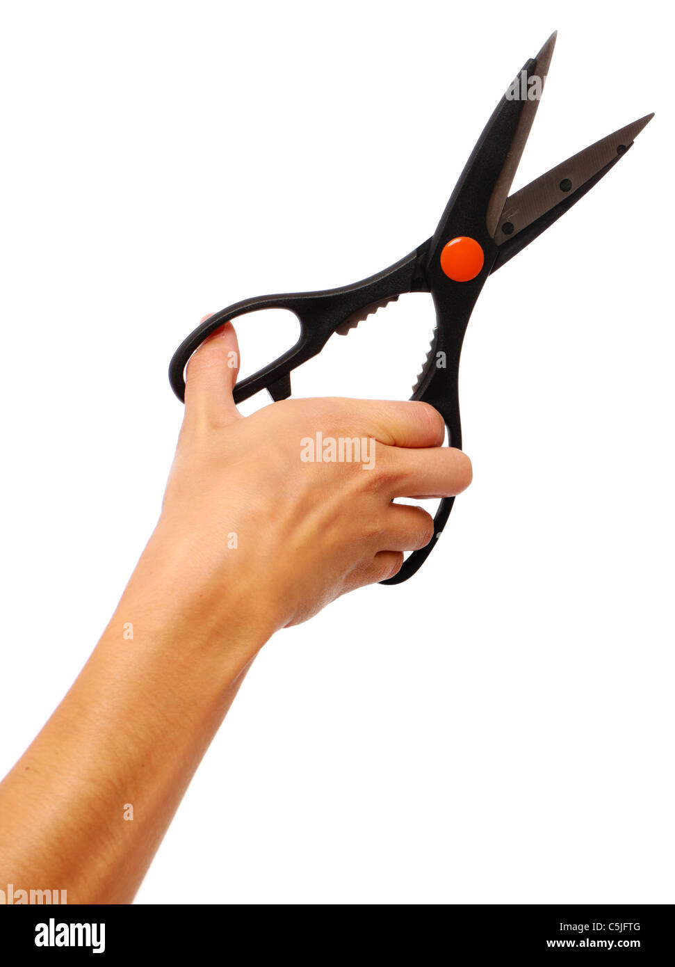 a female hand holding a pair of scissors about to cut something Stock