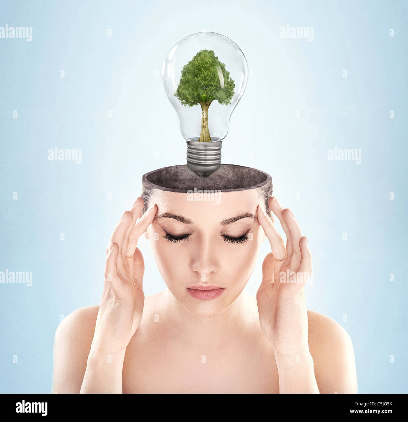 Open minded woman with green energy symbol Stock Photo