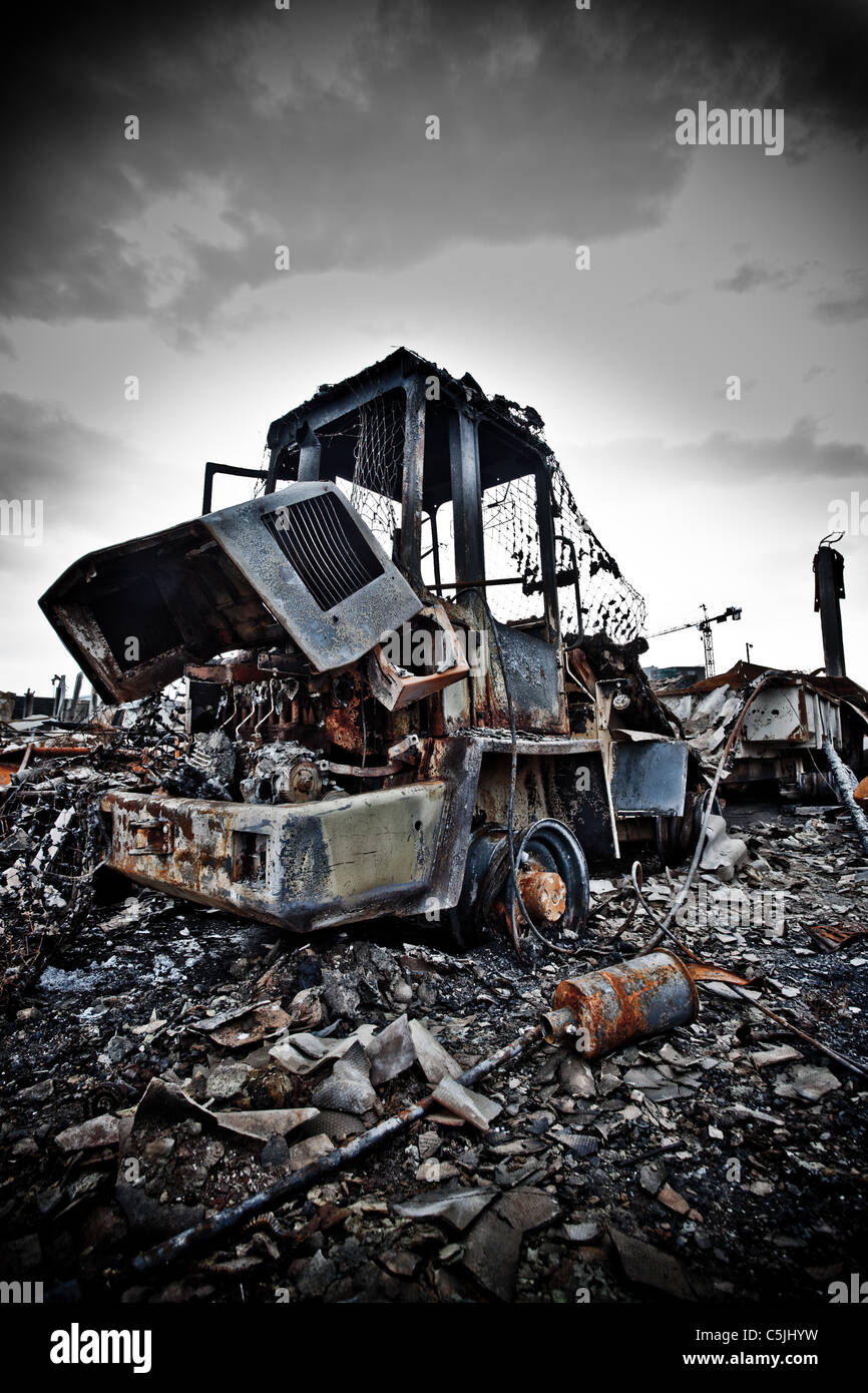 Closeup of derelict fire damaged forklift truck on waste dump Stock