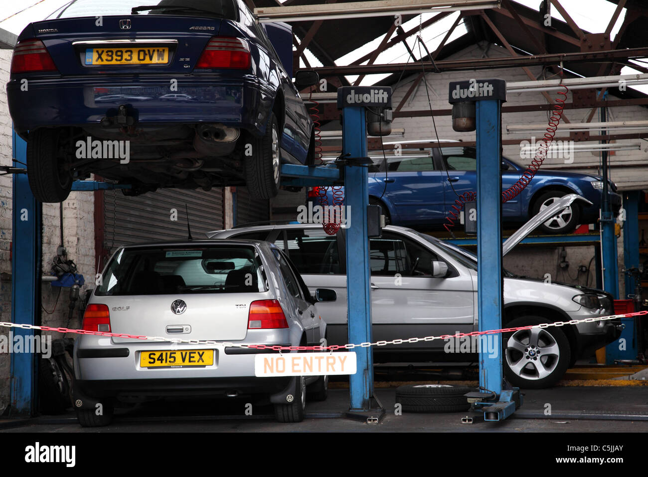 Cars being repaired in a garage in the U.K Stock Photo Alamy