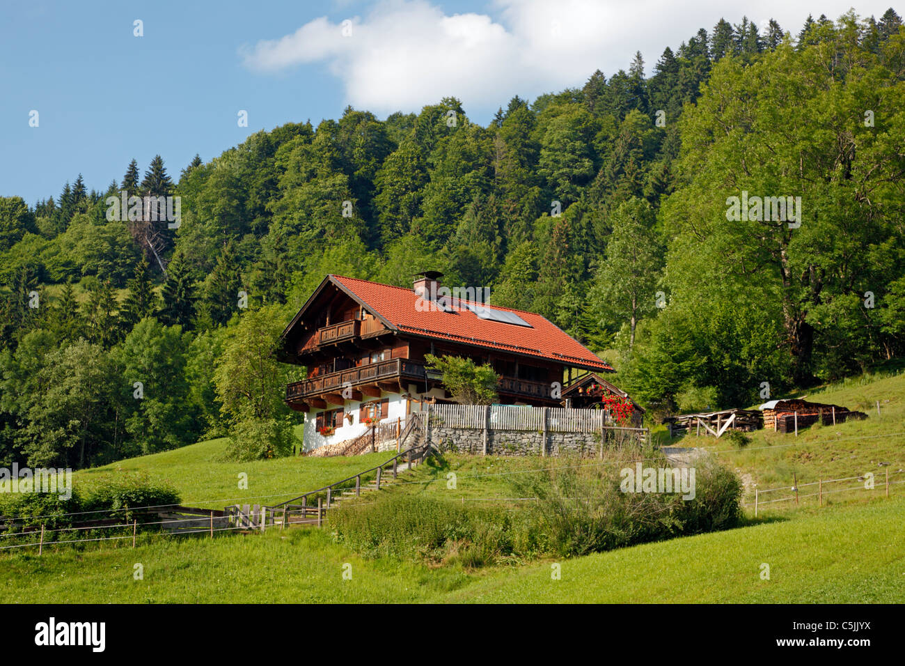 Alpine house with solar heating panels in the roof in the mountains near Partnachklamm in Garmisch-Partenkirchen, Germany Stock Photo