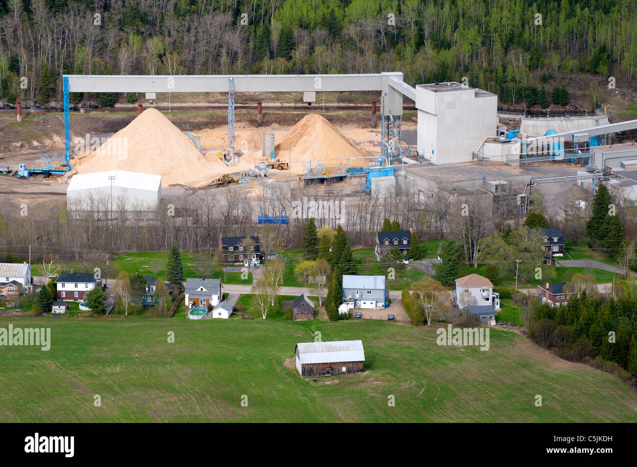 Sawdust mounds at Donohue paper mill in Clermont, region of Charlevoix