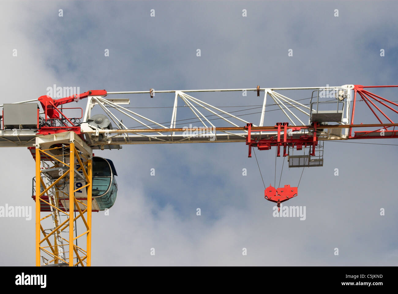 A building construction crane against cloudy blue sky Stock Photo - Alamy