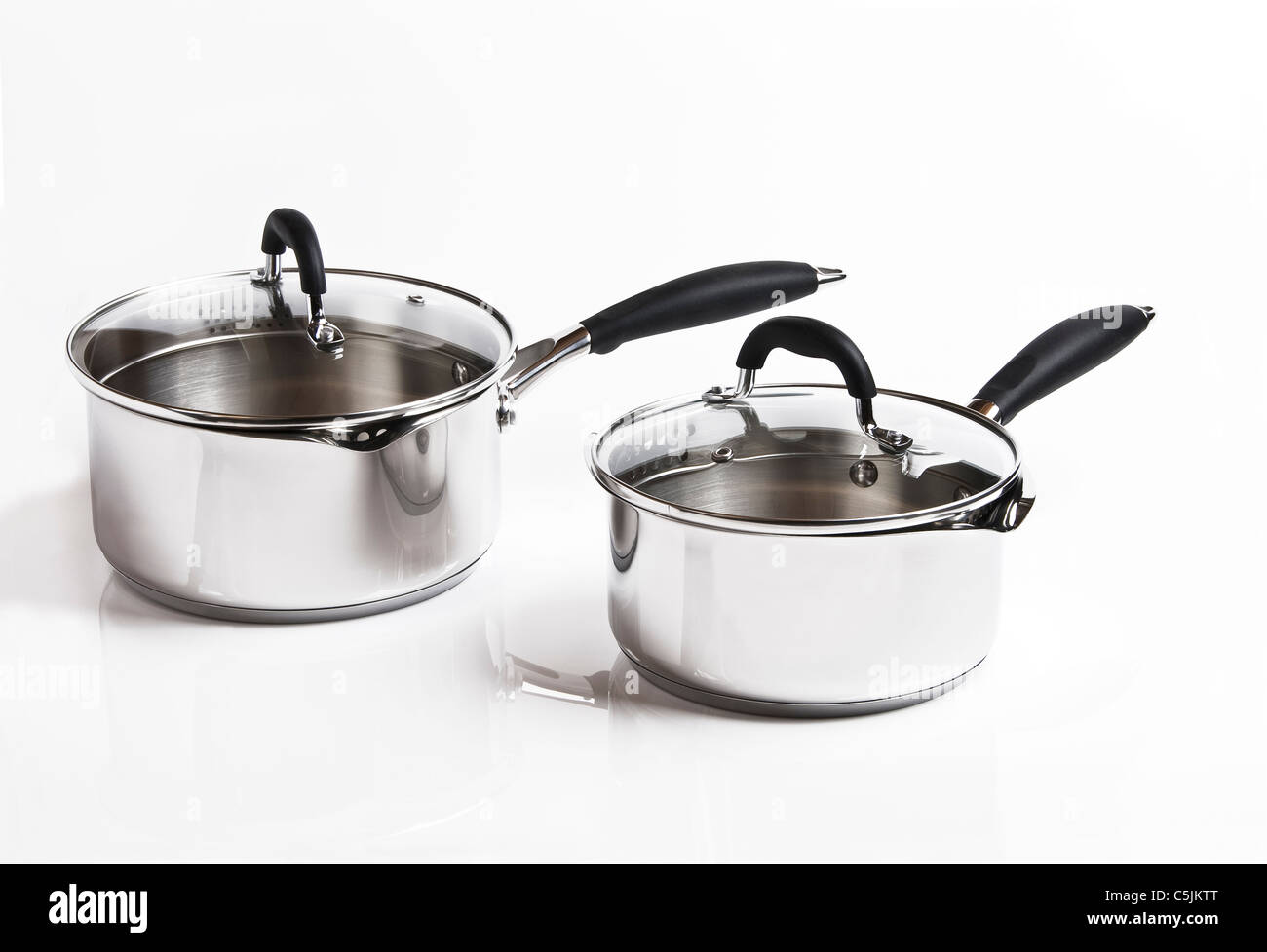 Two stainless steel saucepans, on a white background. Stock Photo