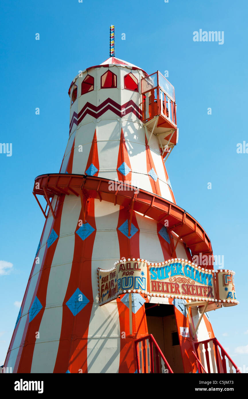 Helter Skelter fairground ride in front of bright blue sky Stock Photo