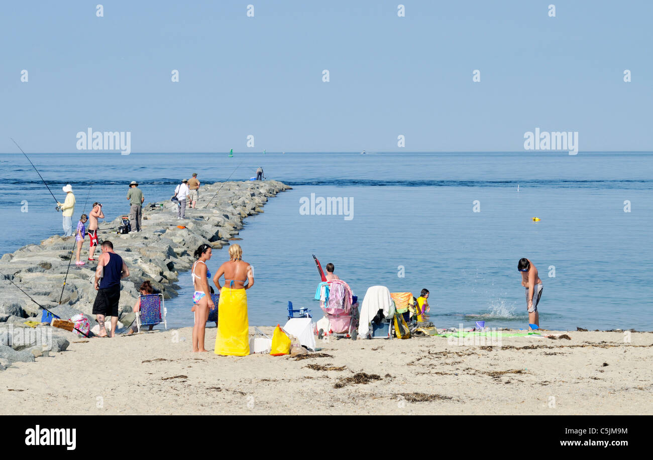 Jetty and beach at the east end of the Cape Cod Canal that opens to Cape Cod Bay on a clear blue