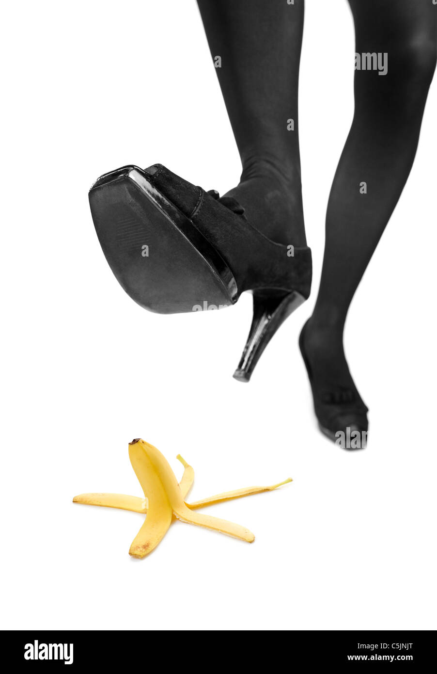 Woman about to step on a banana peel Stock Photo