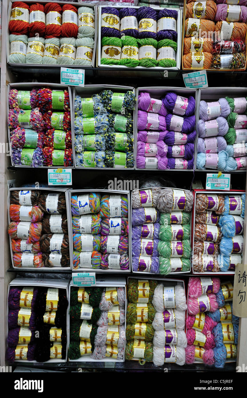Rolls of yarn on a store shelf. Stock Photo