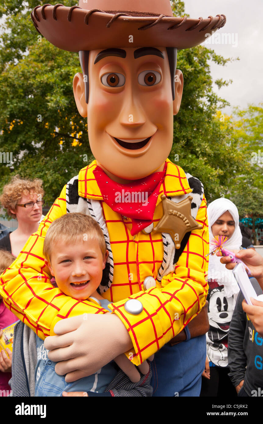 A seven year old boy has his picture taken with Woody ( Toy Story Character ) at Disneyland Paris in France Stock Photo