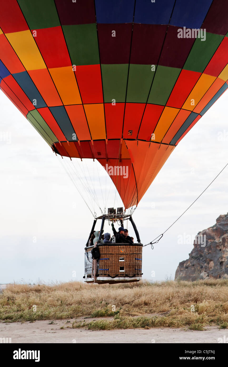 June 2011 hot air balloon loaded with passengers lifts off, portrait. Cappadocia, Kapadokya, Turkey, at point of lift off Stock Photo