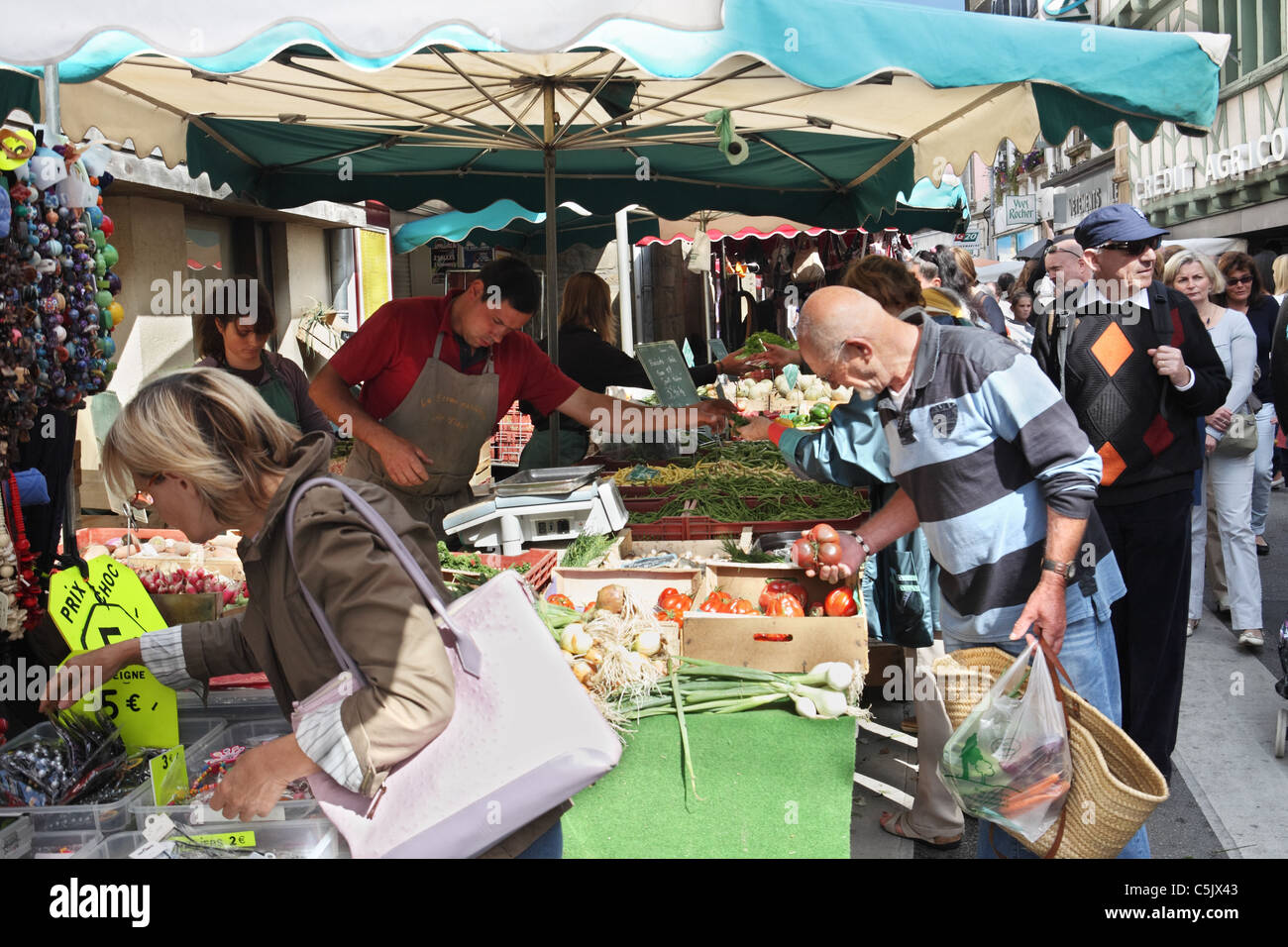People shopping for fruit and vegetables within Auray street market, Brittany, France Stock Photo