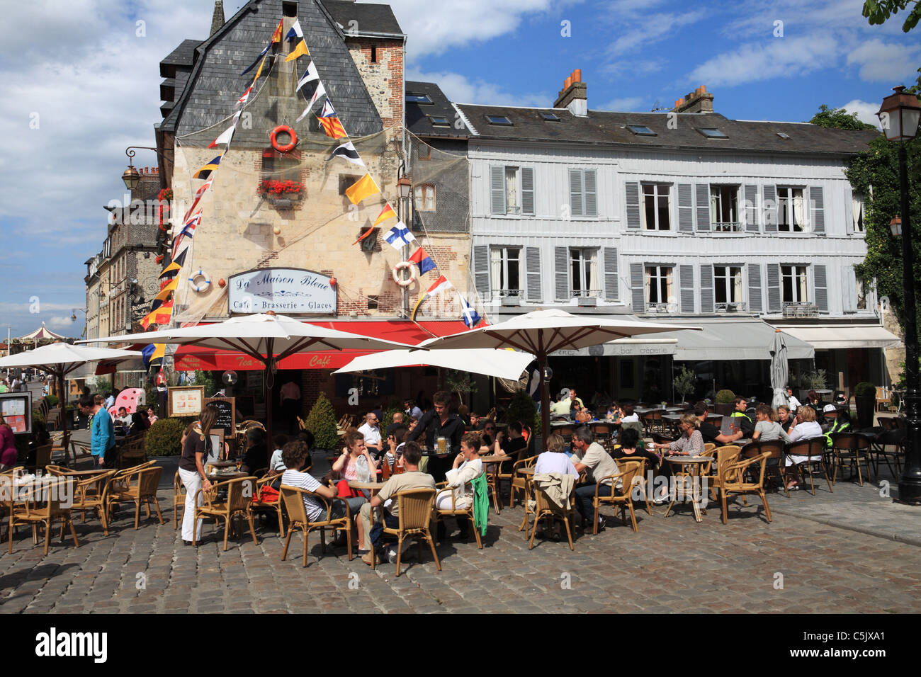 People dining at La Maison Bleue restaurant in Honfleur harbour, Normandy, France Stock Photo