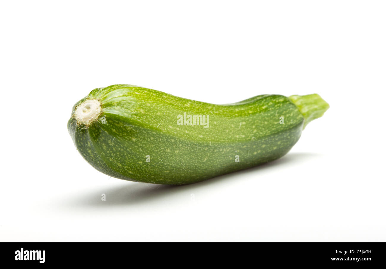 Single Courgette or zucchini from low perspective isolated on white. Stock Photo