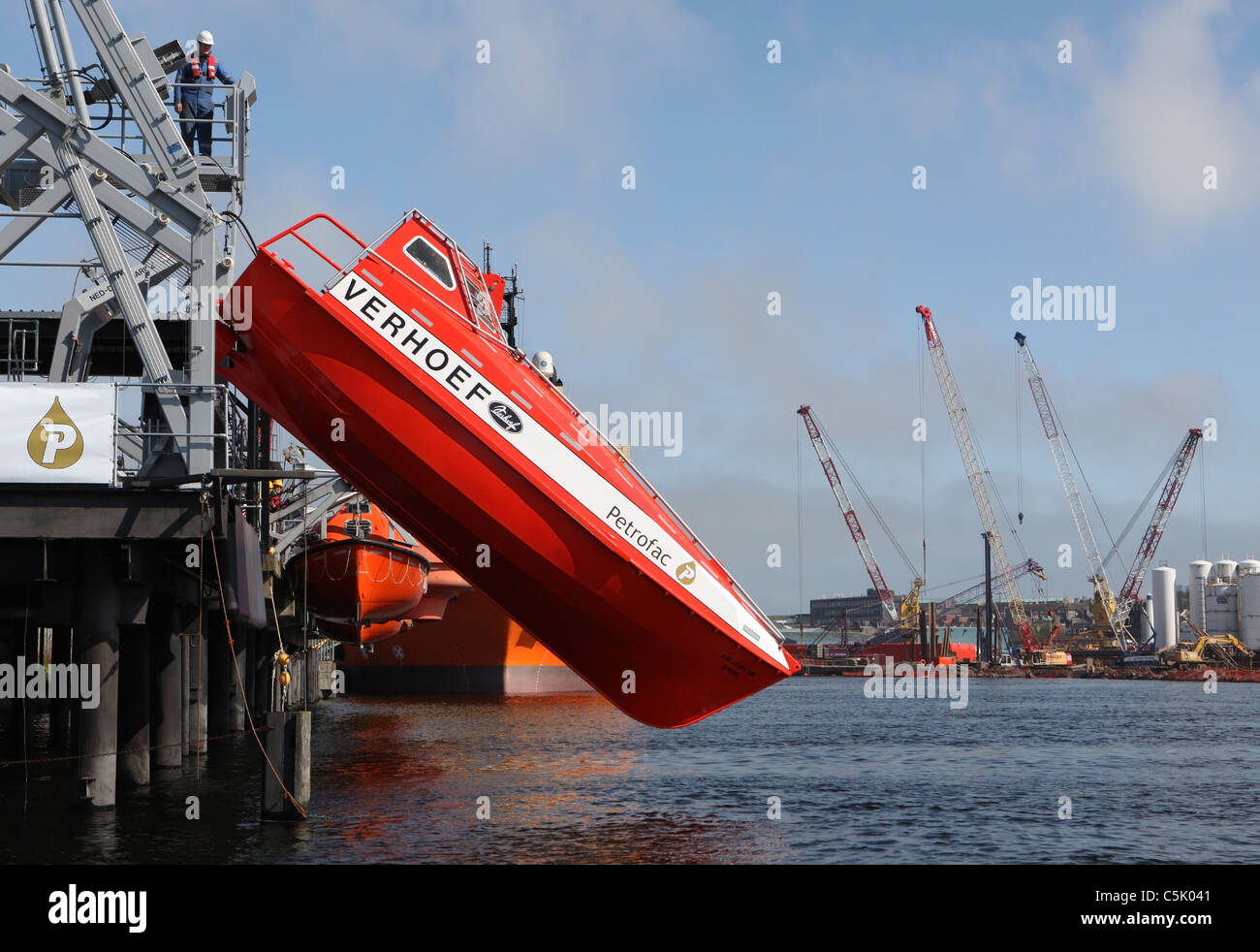 Sequence (see other images) of a free fall lifeboat trainer being dropped into the water. Stock Photo