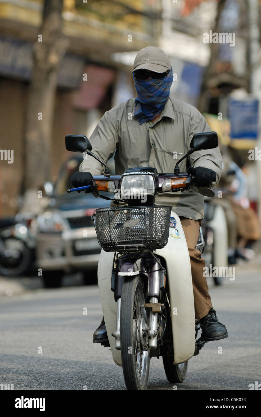 Vietnamese Motorcycle Rider Asia, Vietnam, Hanoi. Hanoi old quarter. Vietnamese men riding on a ...