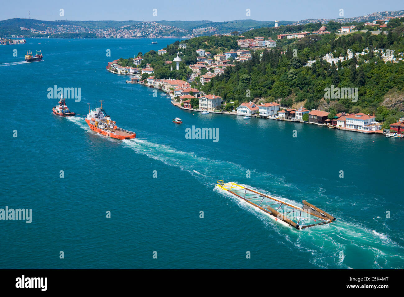 Boats towing a module of a natural gas platform through the Bosphorus, aerial, Istanbul, Turkey Stock Photo