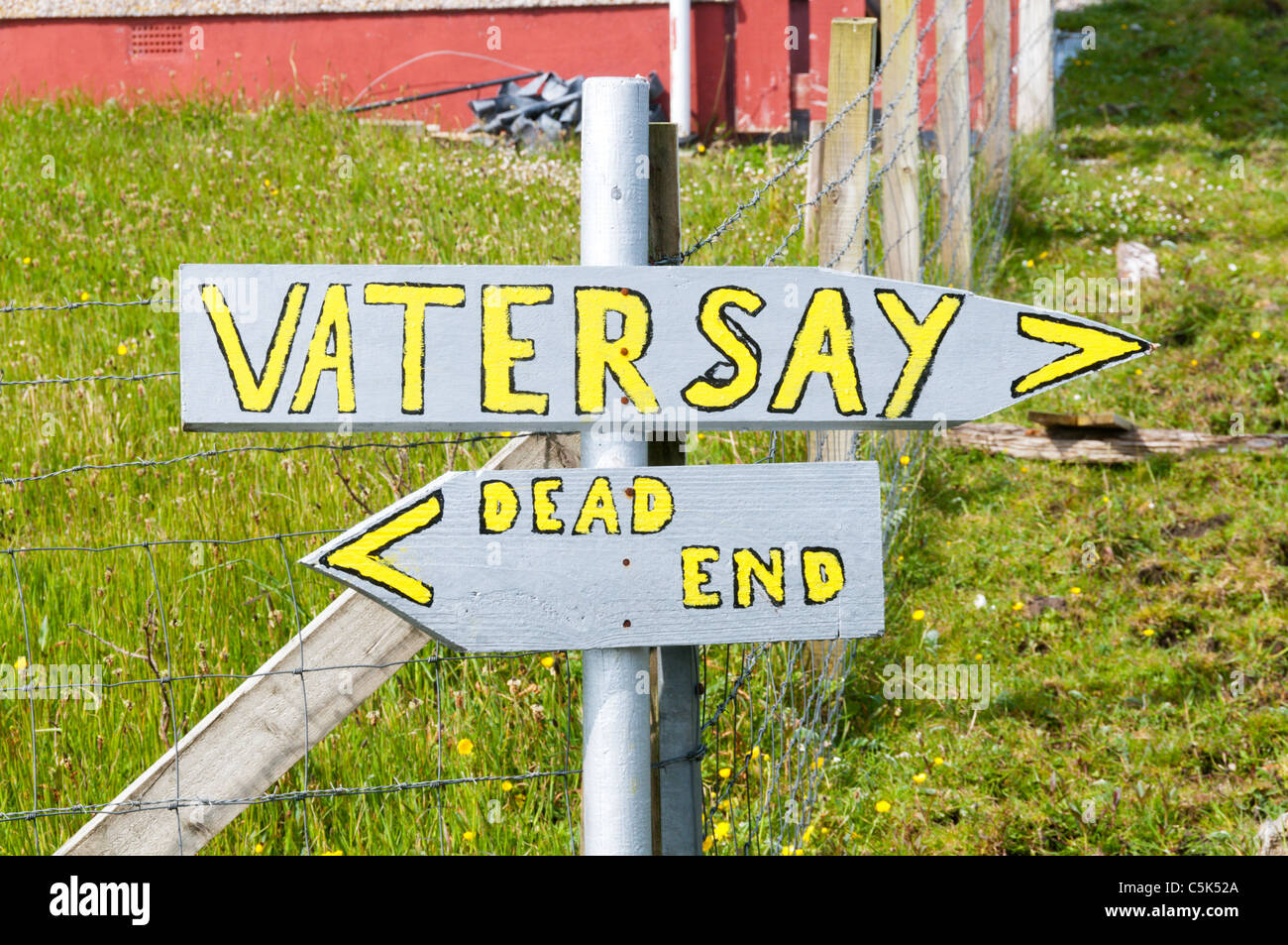 A hand-painted sign on the Hebridean island of Vatersay at the end of the causeway from the neighbouring island of Barra. Stock Photo
