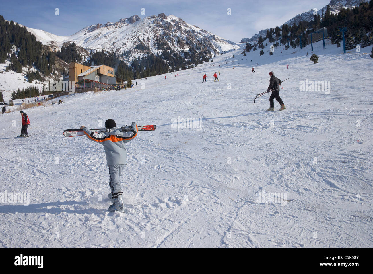 Skiers and snowboarders, snowy ski resort of Chimbulak, Kazakhstan Stock Photo
