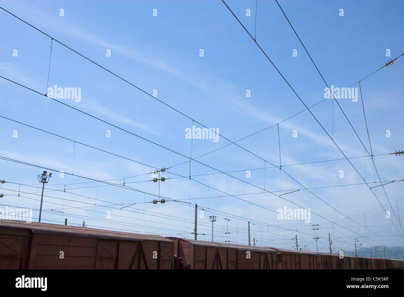 Freight train and power lines as seen from inside the railroad station, Fevzipasa, near Gaziantep / Antep, Turkey Stock Photo