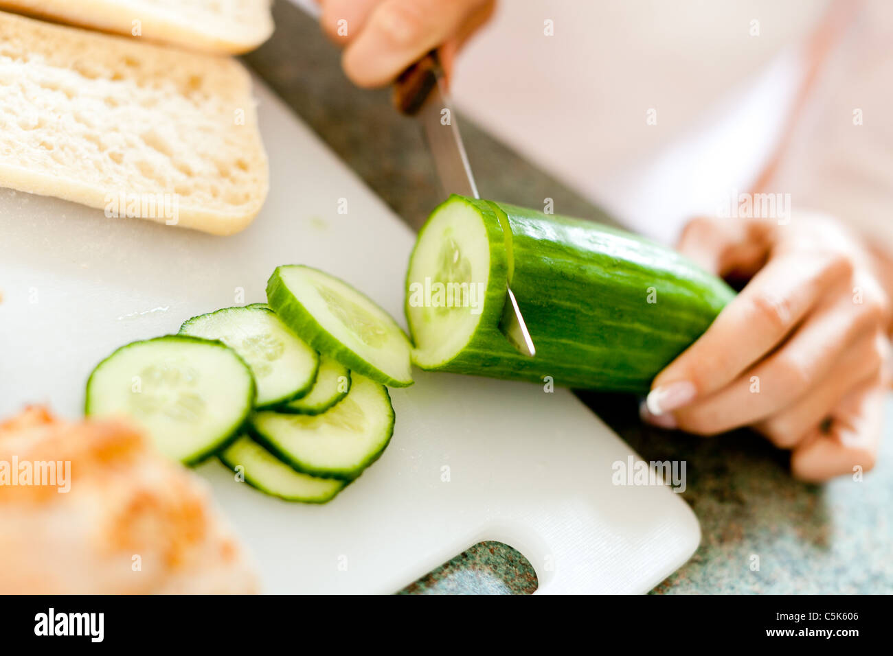 Woman cutting Cucumber Stock Photo Alamy