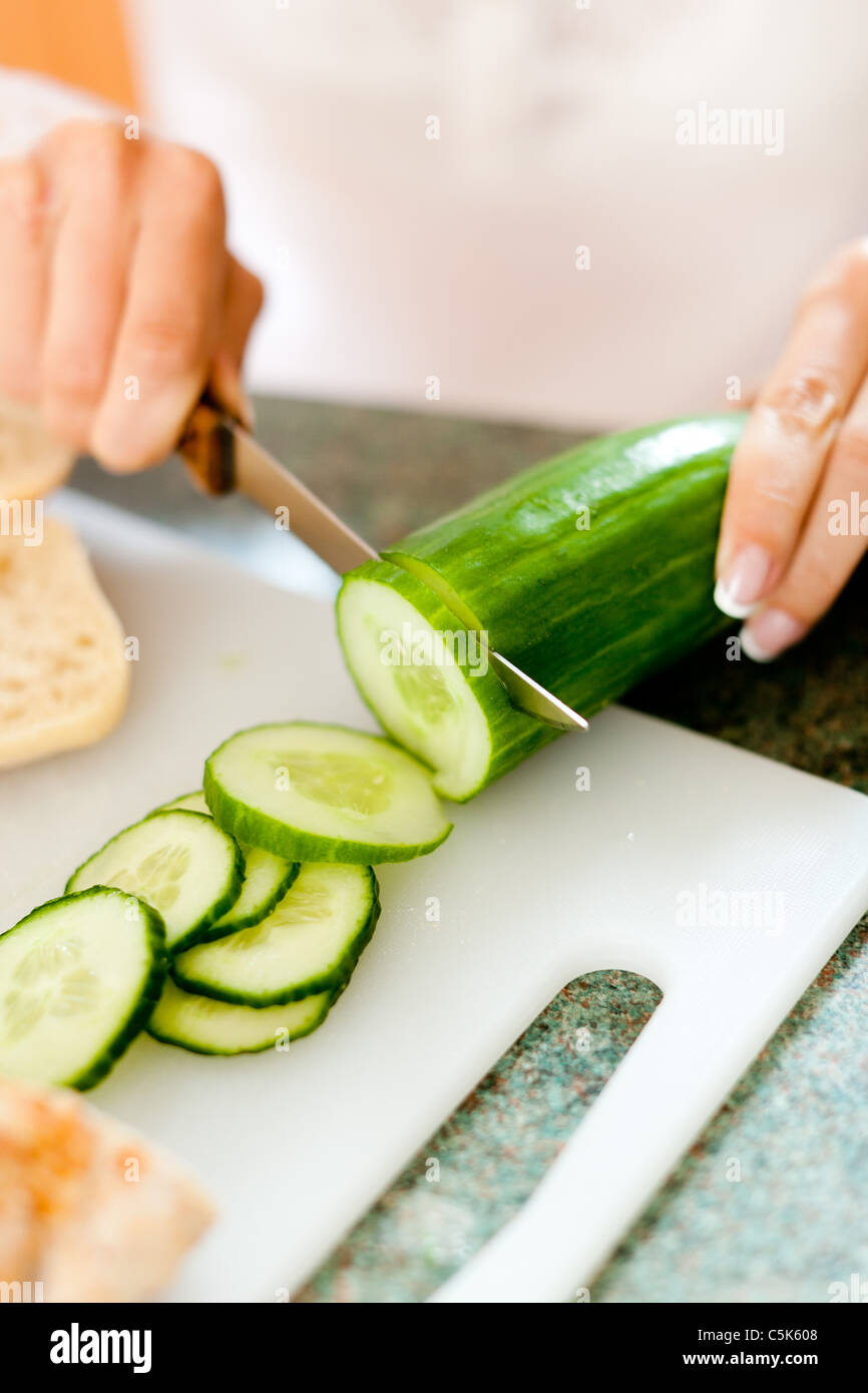 Woman cutting Cucumber Stock Photo Alamy