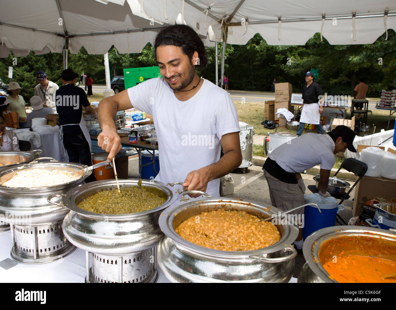 A man prepares large quantities of curry Stock Photo