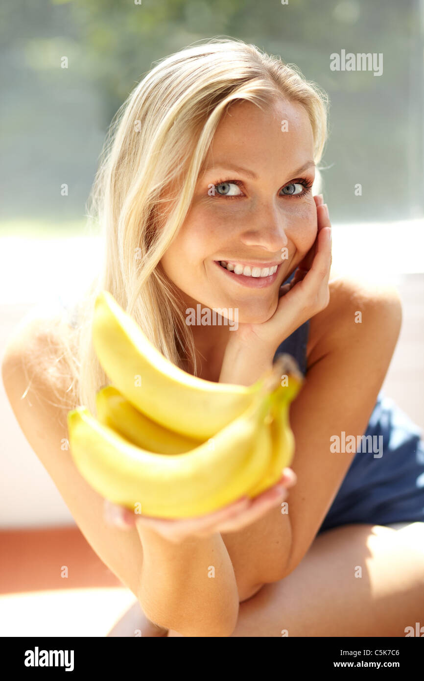 Woman holding bunch of Bananas Stock Photo Alamy