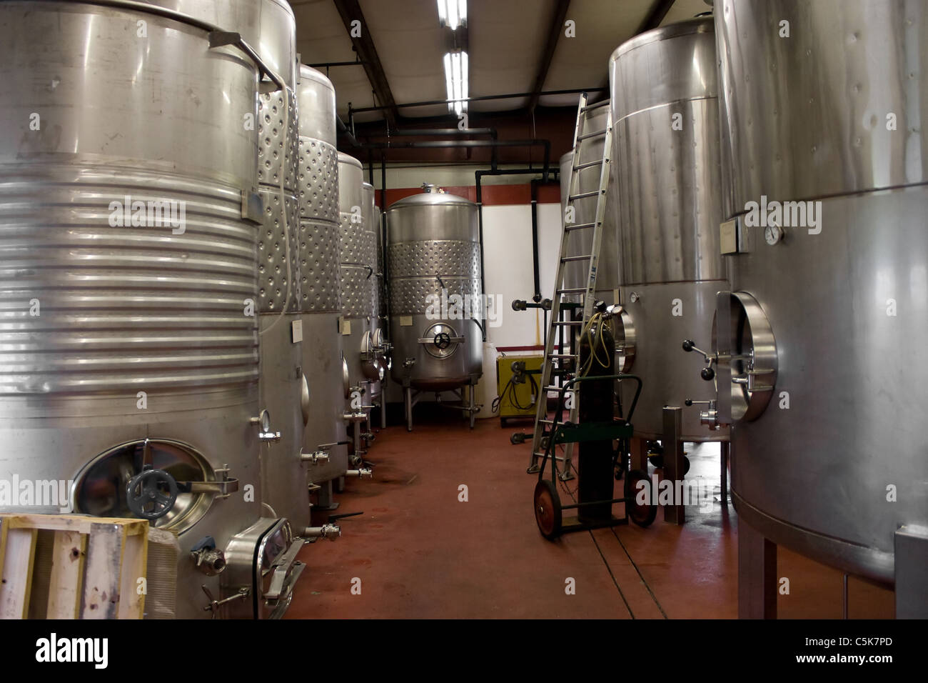 Modern aluminum barrels where grape juice is aged into wine located in a vineyard cellar. Stock Photo