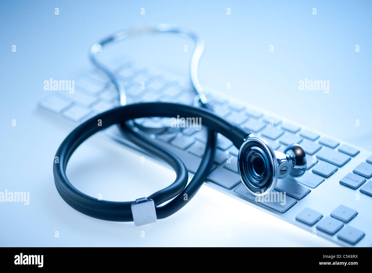 Medical stethoscope on a computer keyboard in blue, closeup Stock Photo ...